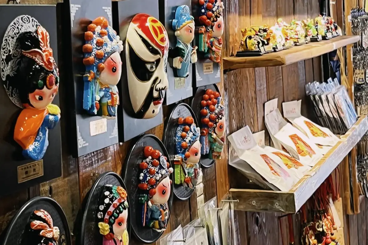 A shop wall of colourful Sichuan-opera face-mask souvenirs at Ciqikou, Chongqing.