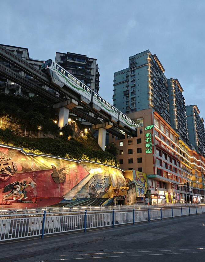 Liziba metro train passing through a residential building, Chongqing Line 2.