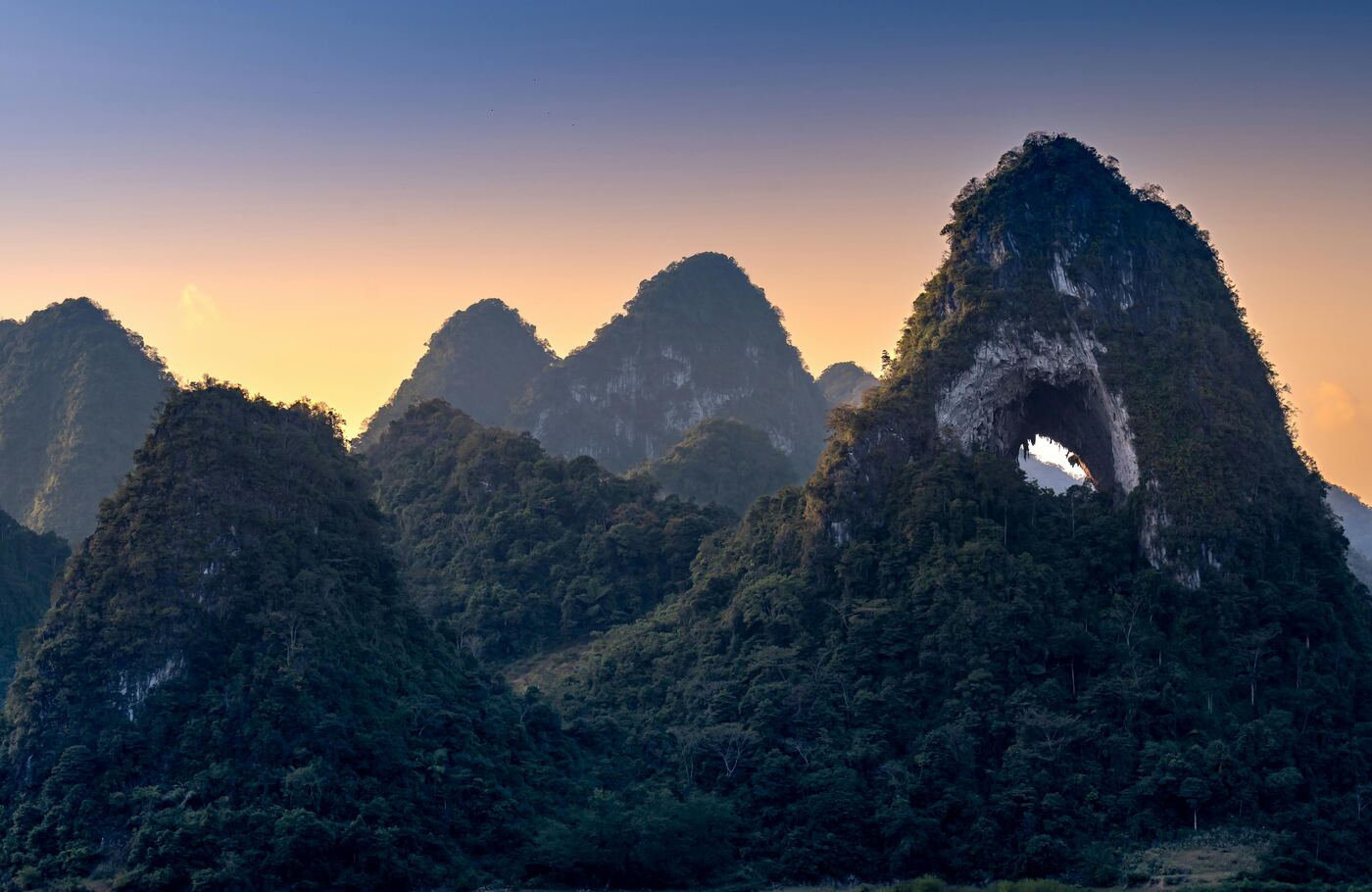 Moon Hill near Yangshuo, a karst peak with a large semicircular arch through its summit.