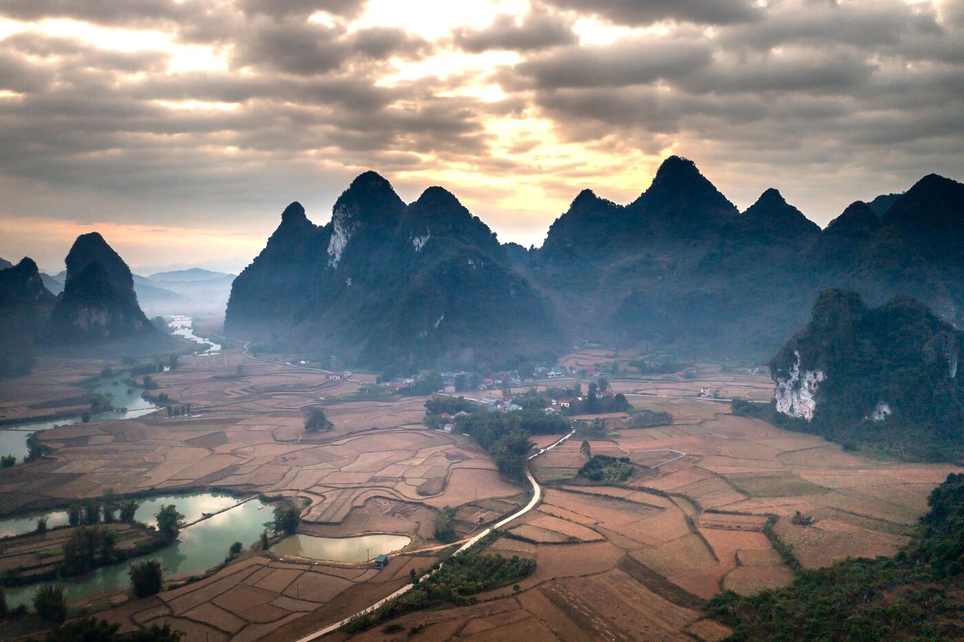 Dawn light over a sweeping bend of the Li River seen from Xianggong Mountain near Yangshuo.
