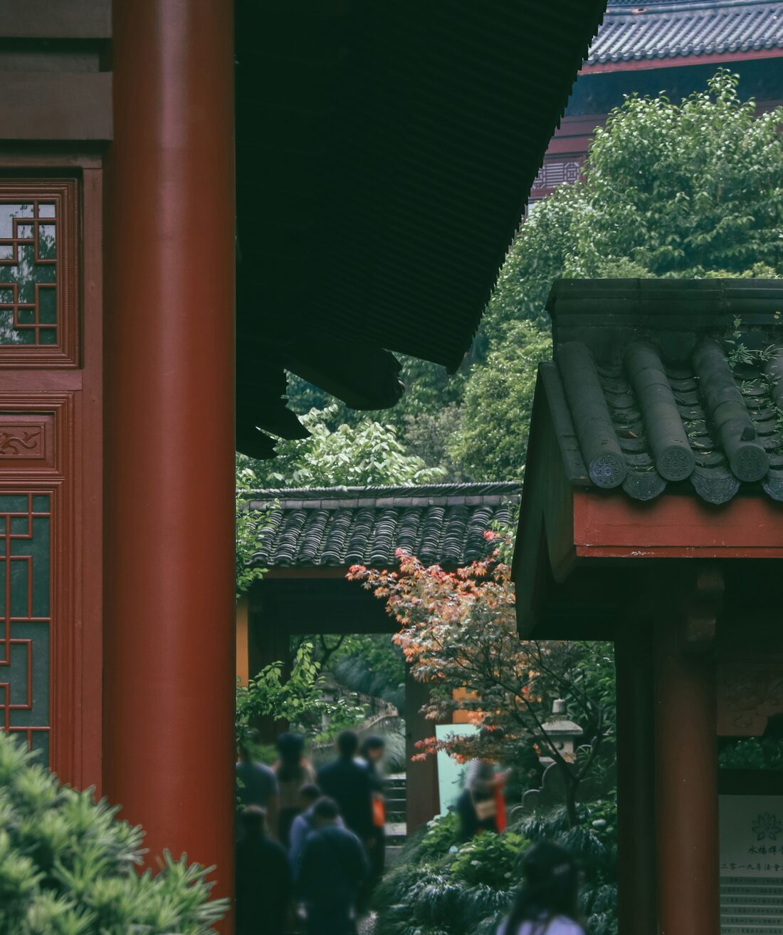 Carved Buddhist figures and temple detail at Lingyin Temple's Feilai Feng scenic area, Hangzhou.