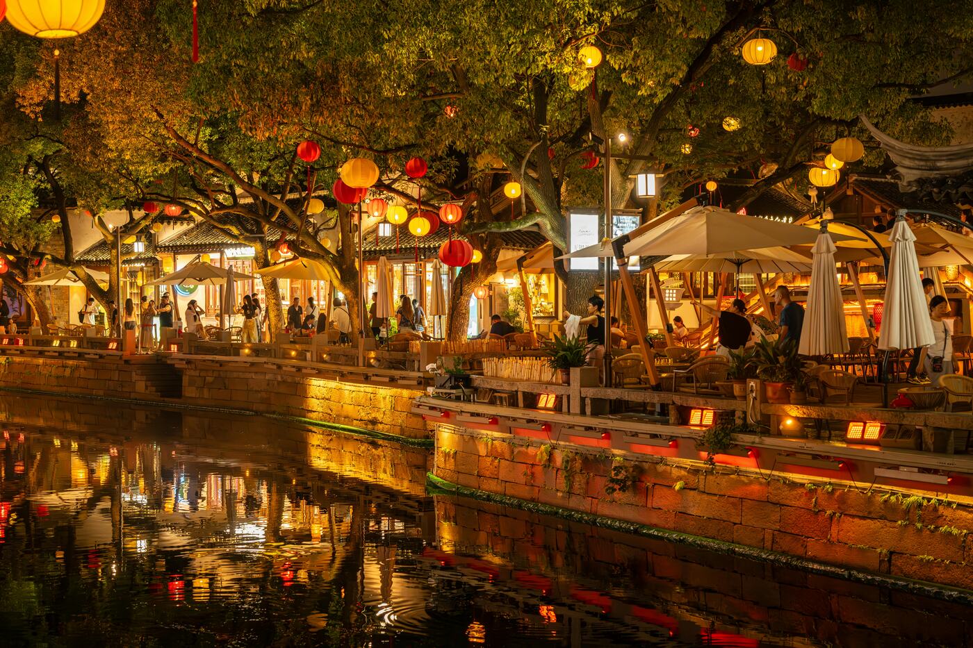 Qinghefang old street in Hangzhou — restored low wooden shopfronts and pedestrian crowds.