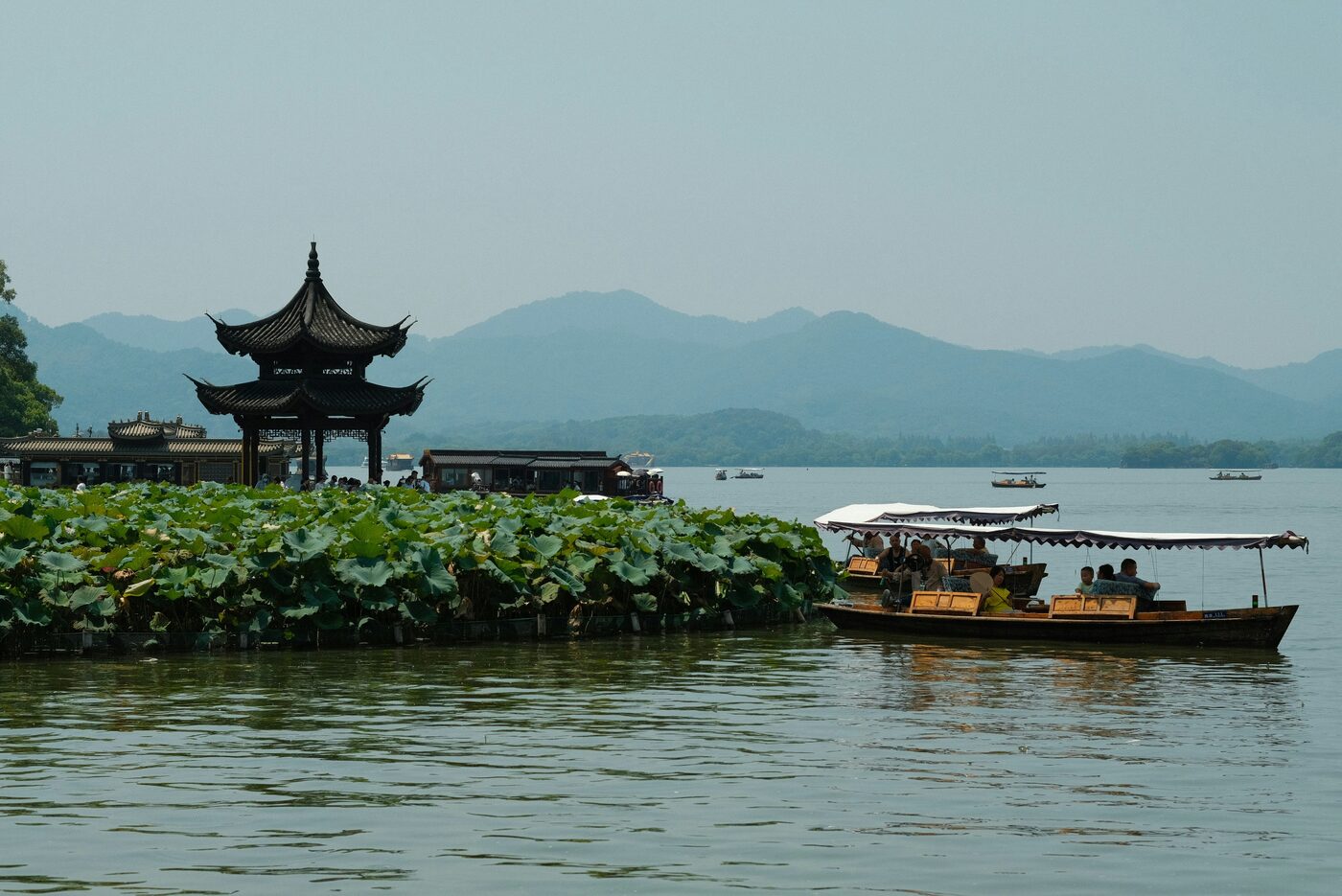 West Lake in Hangzhou — willow-lined causeway and pagoda across the water, a UNESCO cultural landscape.