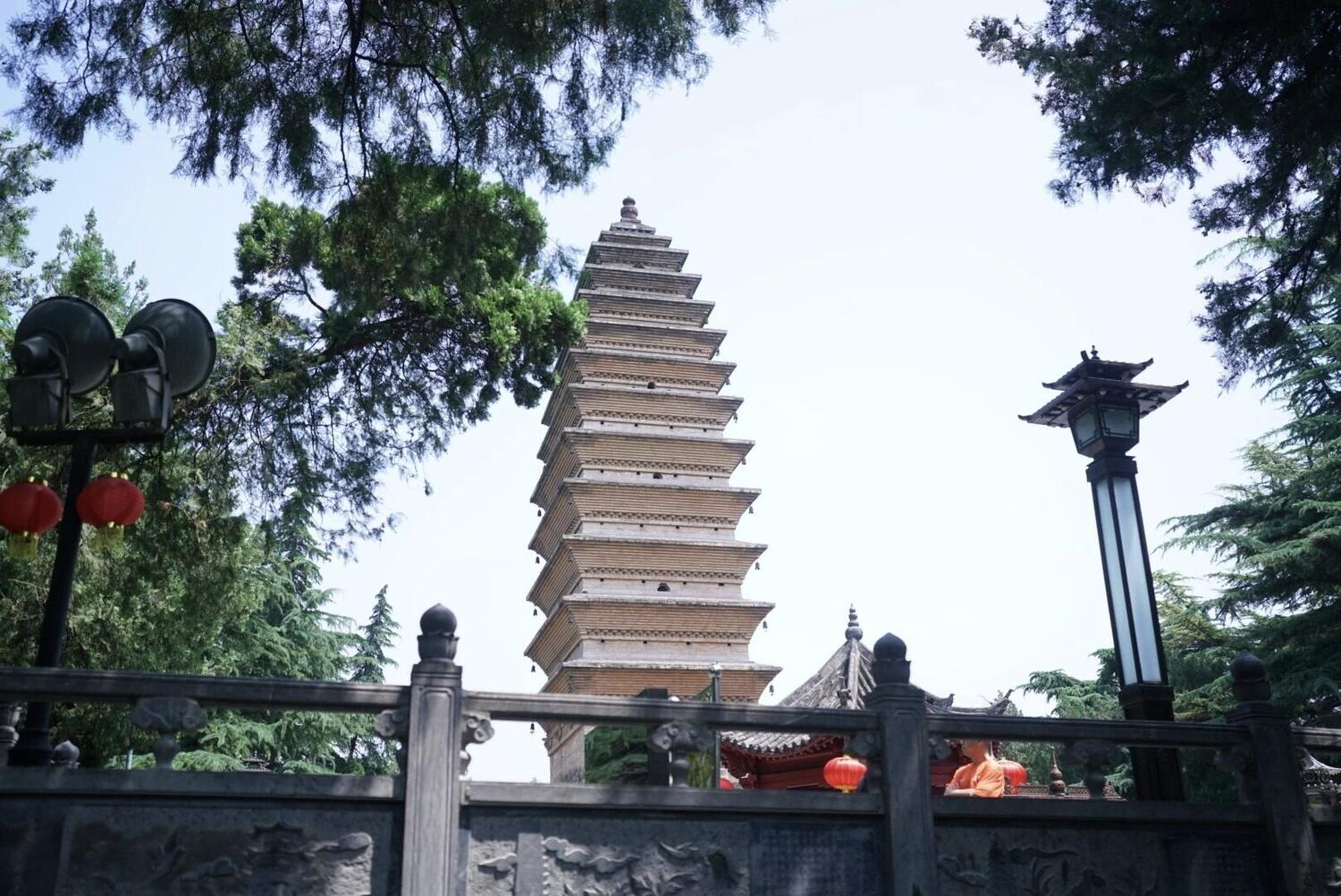 The tall multi-storey square brick Qiyun Pagoda rising above the trees in its courtyard at White Horse Temple, Luoyang.