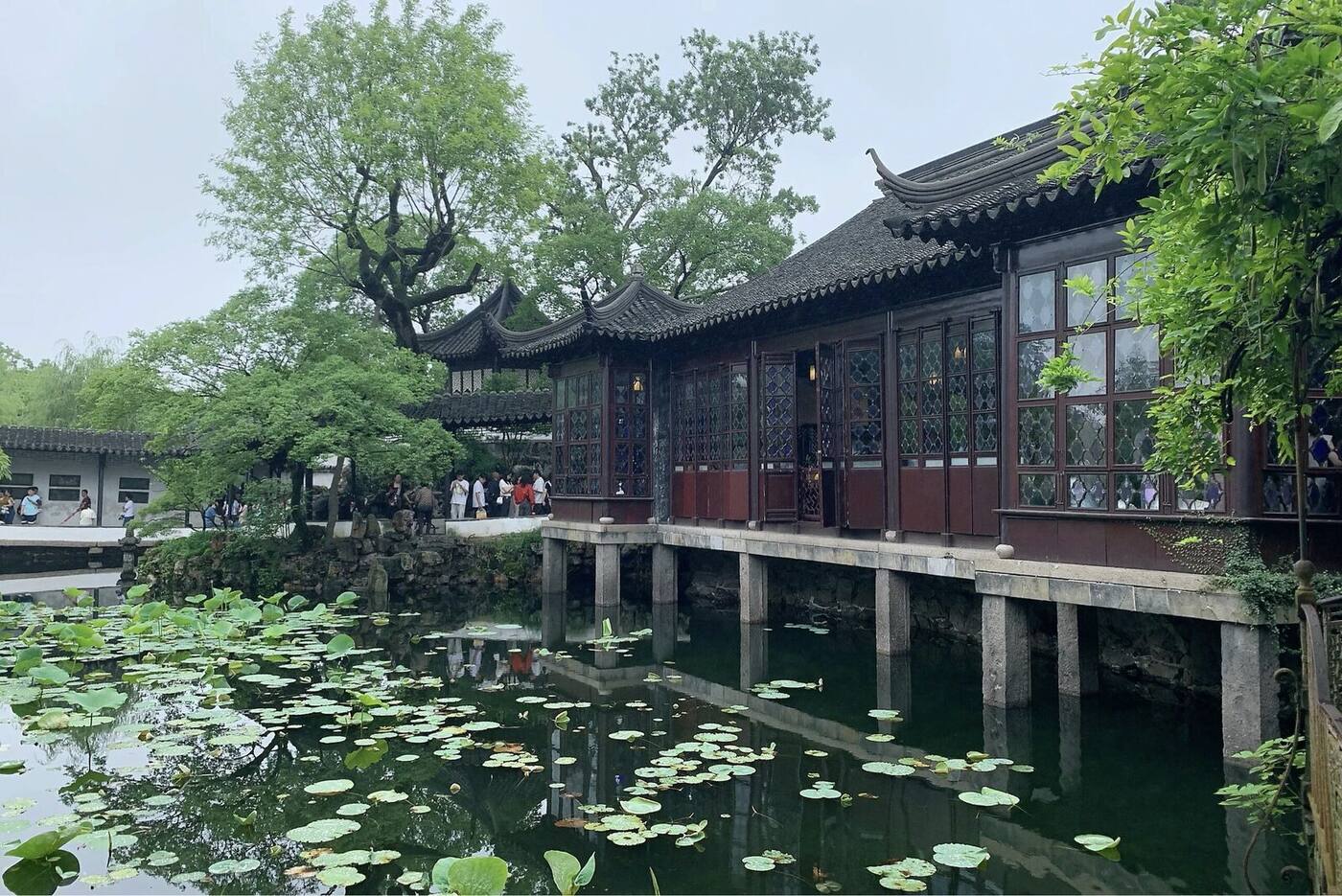 A covered waterside gallery and lotus pond at the Humble Administrator's Garden, one of the UNESCO classical gardens of Suzhou.