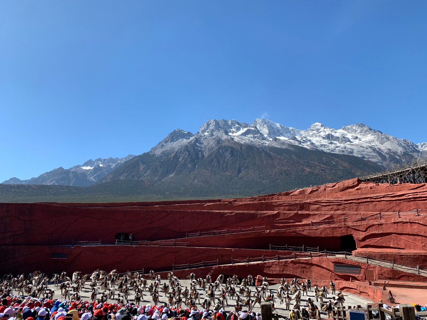The terraced open-air theatre of the Impression Lijiang show, with the snow peaks of Jade Dragon Snow Mountain as the backdrop.