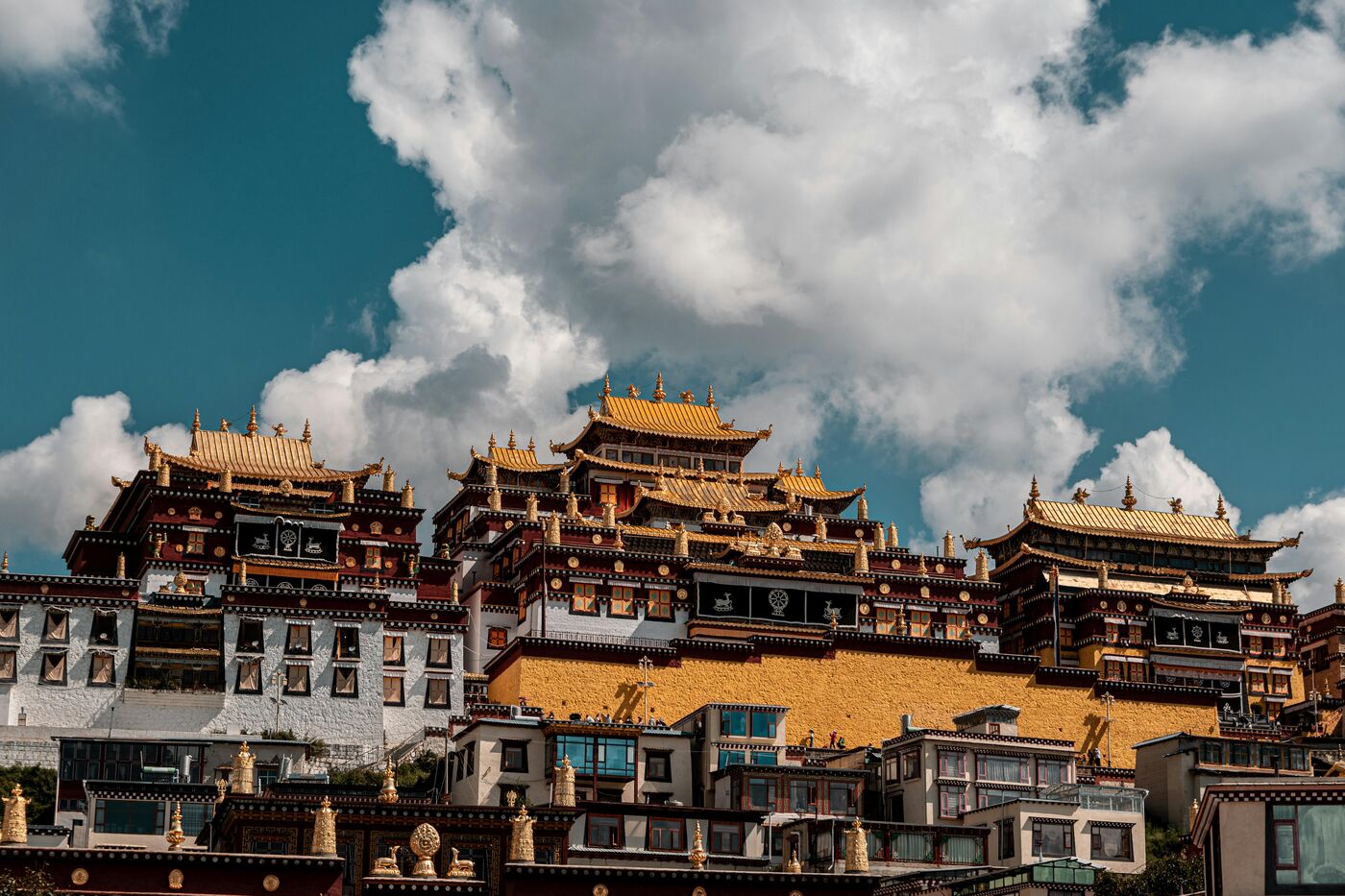 Songzanlin Monastery near Shangri-La, Yunnan — a Tibetan Buddhist complex of golden roofs on a hillside.
