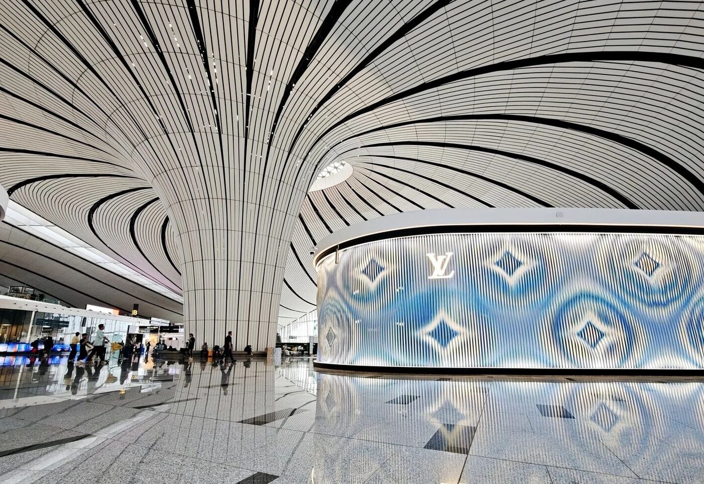 The flowing ribbon-vaulted interior of Beijing Daxing International Airport (PKX), designed by Zaha Hadid Architects.