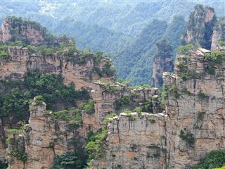 The Natural Great Wall peak-walls at Yangjiajie — blade-thin sandstone ridges stacked behind each other.